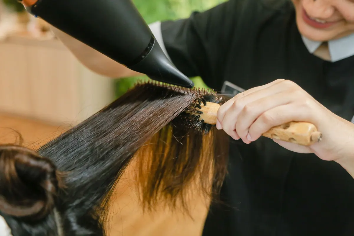 Round-brush blowout styling in golden light