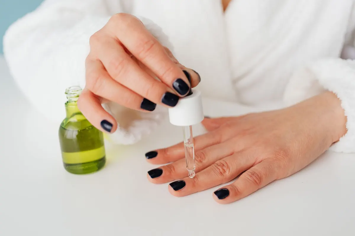 Nail technician applying polish during a manicure