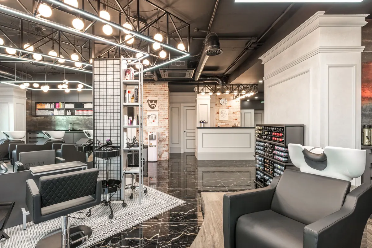 Salon product counter against a warm exposed-brick wall