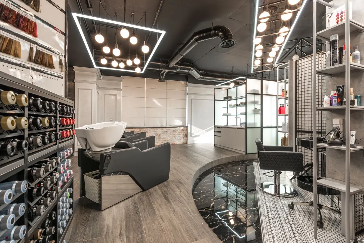 Bright salon interior with styling chairs and warm pendant lighting