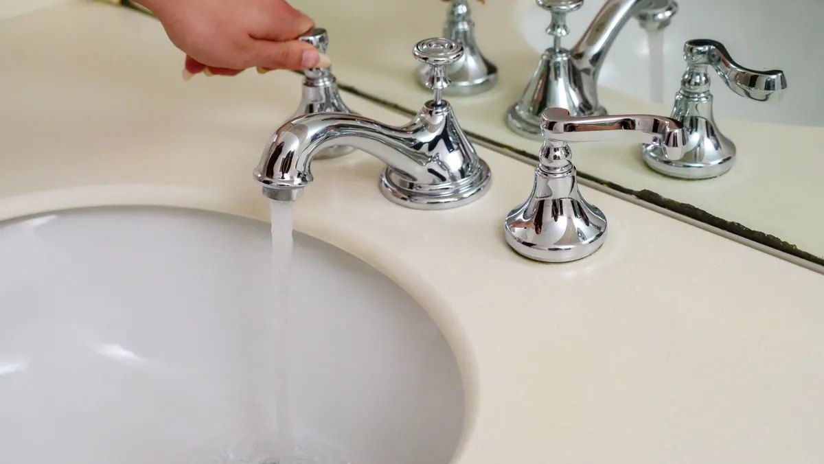 New polished chrome faucet running clean water